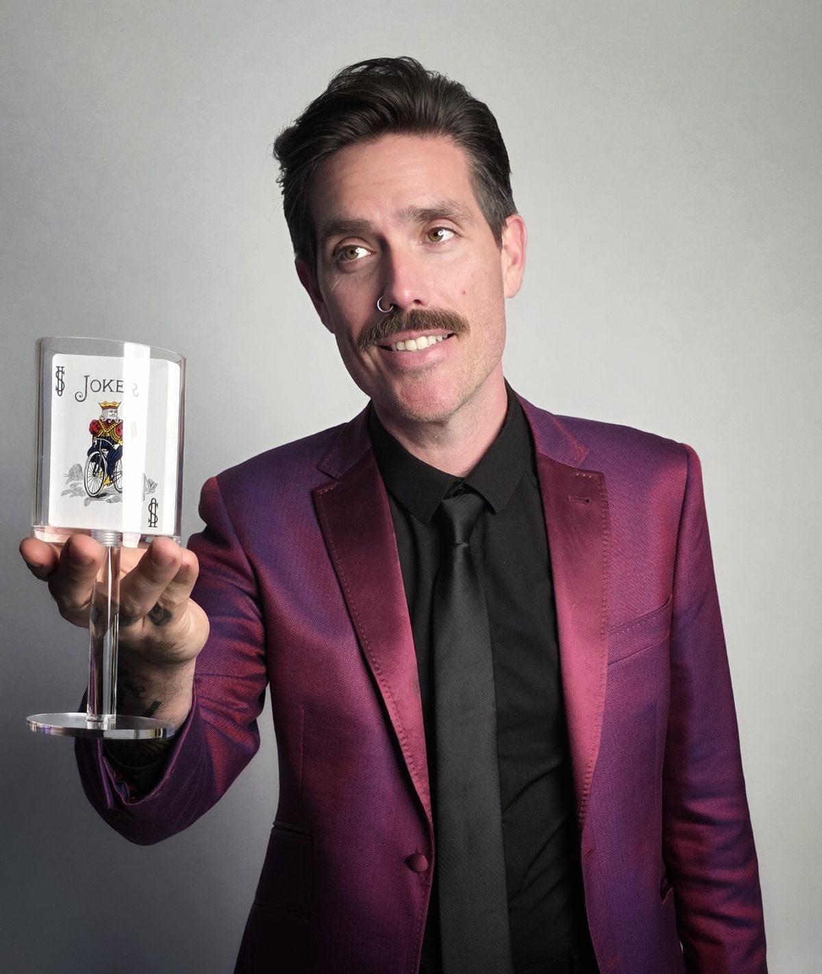 Alfonso Gonzales — magician in San Antonio holding a card trick illusion